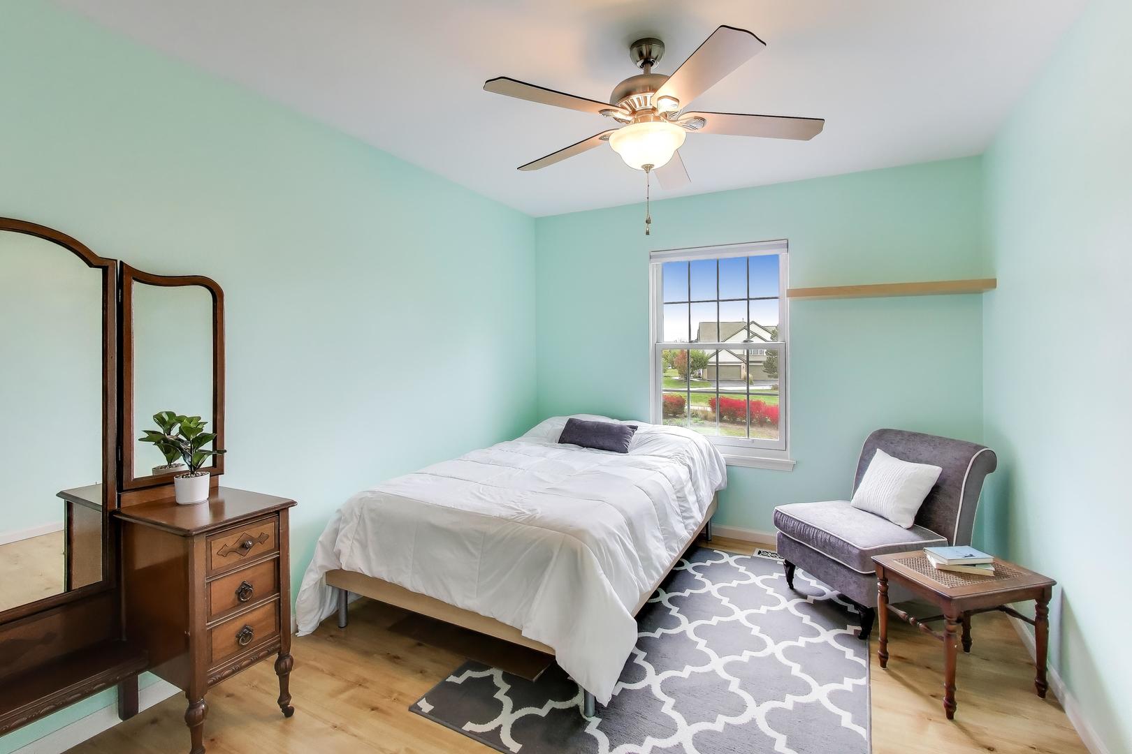 470 Country Place Lindenhurst, IL 60046 - Photo 15 of 29 a bedroom with a bed and a chandelier