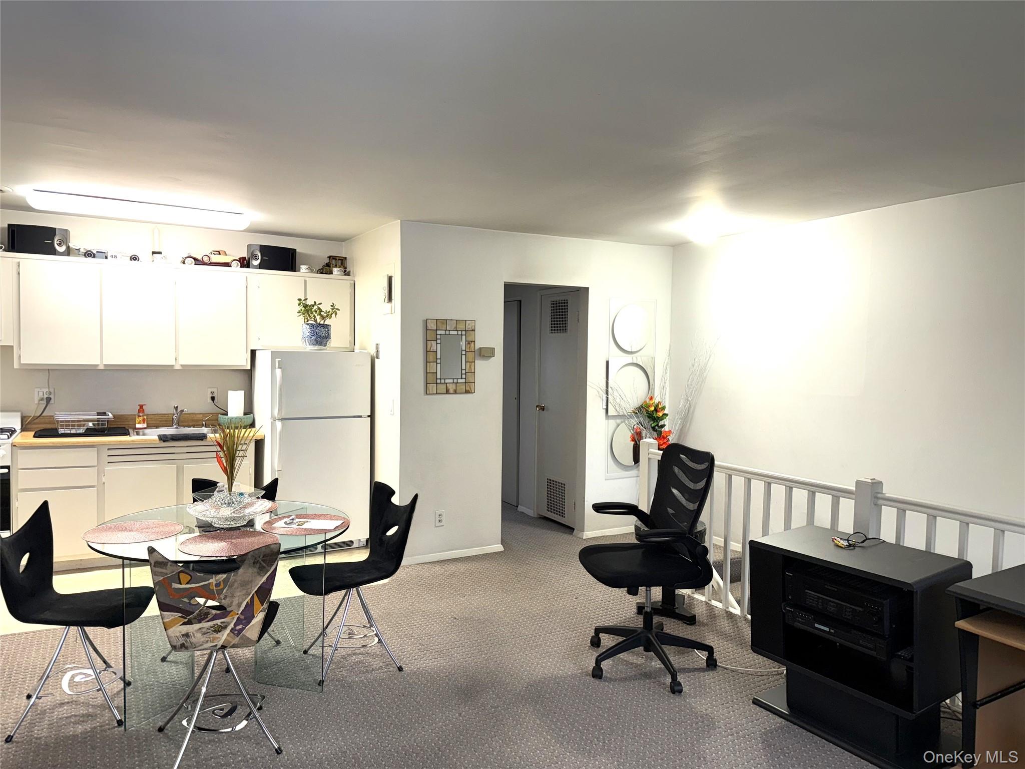 3 Wyndover Woods Lane, Unit 10 White Plains, NY 10603 - Photo 3 of 11 Living area with light carpet and baseboards