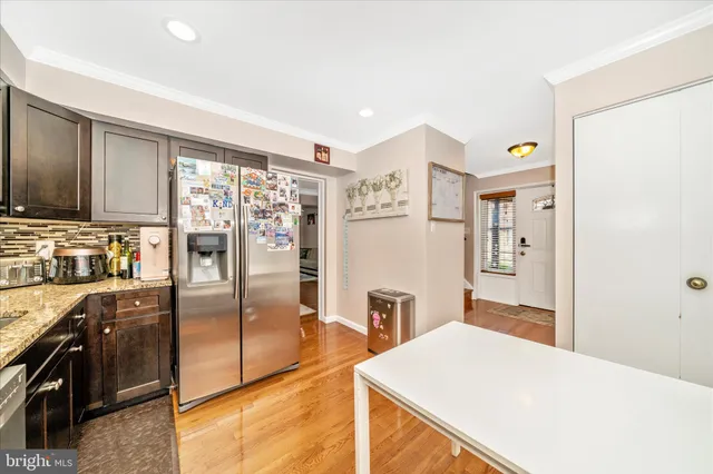 a kitchen with stainless steel appliances a refrigerator and a stove top oven