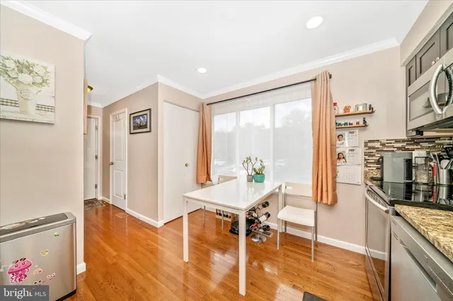 a living room with furniture a flat screen tv and a floor to ceiling window