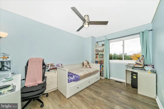 a bed room with a bed and a chair