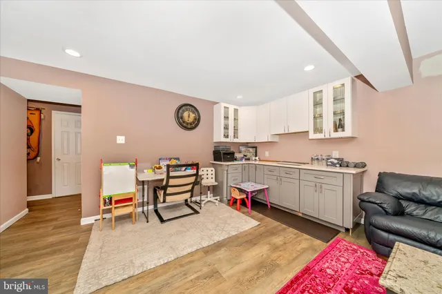 a kitchen with a refrigerator and white cabinets