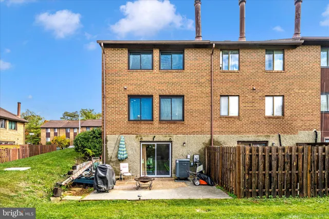 a view of a house with backyard porch and sitting area