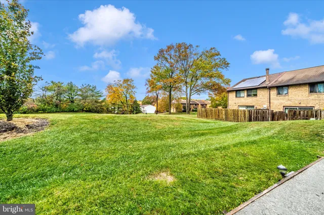 a view of yard with swimming pool and green space