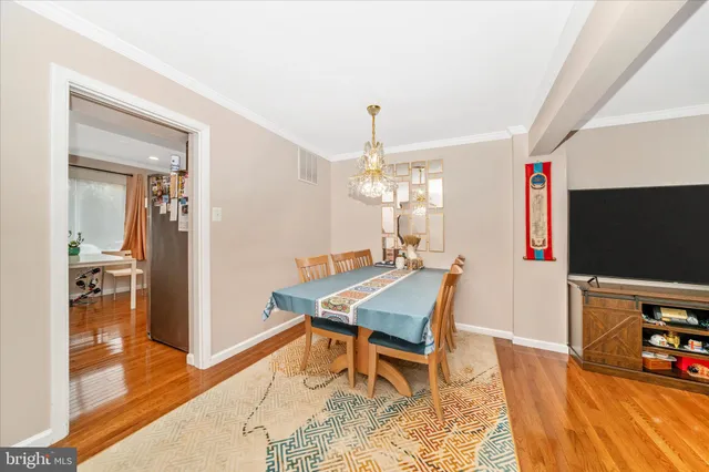 a dining room with furniture and wooden floor