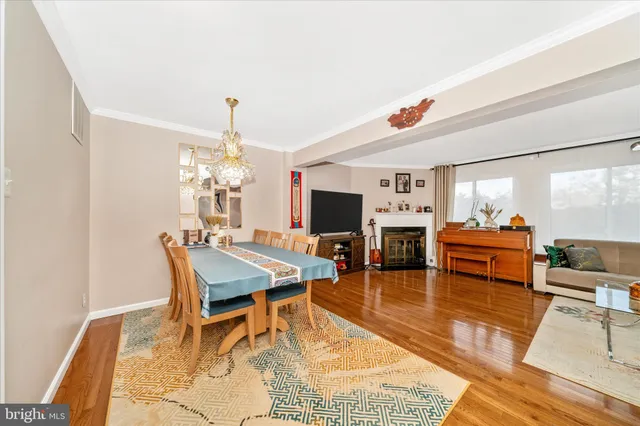 a living room with furniture dining table and a chandelier