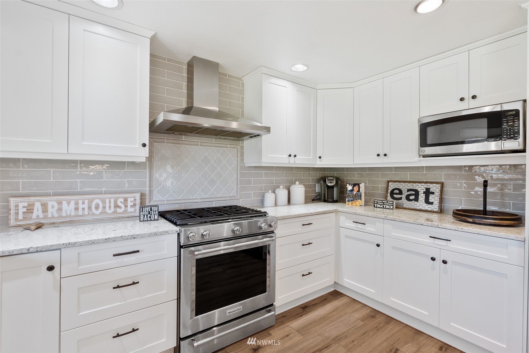 21847 Frager Road South Kent, WA 98032 - Photo 15 of 34 a kitchen with granite countertop white cabinets and stainless steel appliances