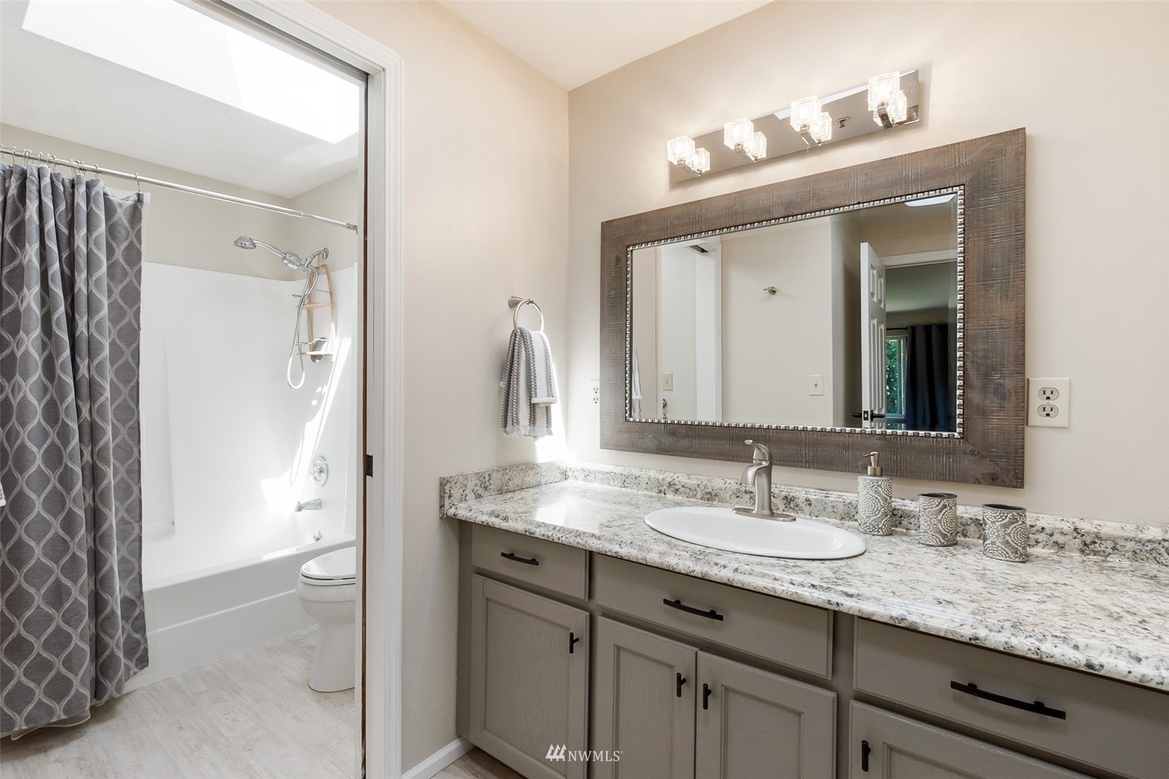 21847 Frager Road South Kent, WA 98032 - Photo 23 of 34 a bathroom with a granite countertop sink and a mirror