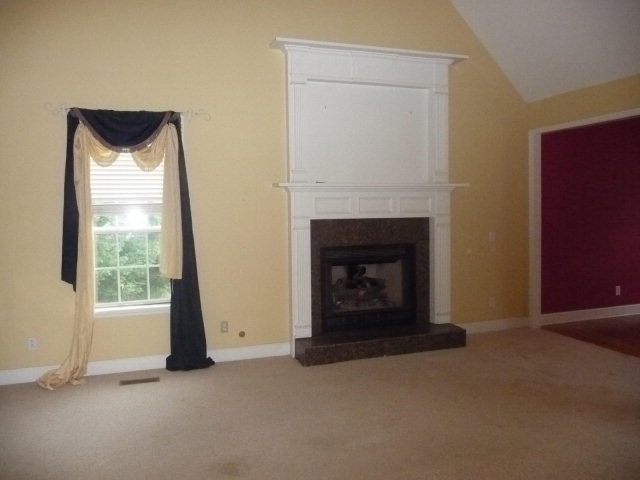 124 Rivoli Ridge Drive Macon, GA 31210 - Photo 4 of 17 an empty room with a fireplace