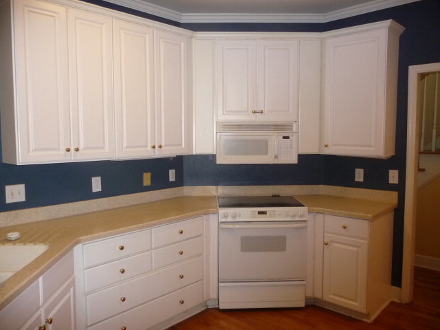 124 Rivoli Ridge Drive Macon, GA 31210 - Photo 6 of 17 a kitchen with white cabinets and white appliances