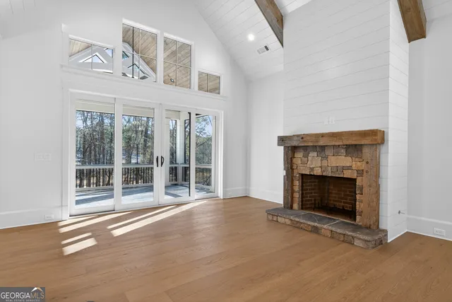 a large kitchen with stainless steel appliances granite countertop a lot of cabinets and wooden floor
