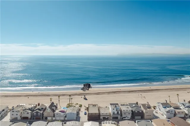 an aerial view of residential building and ocean