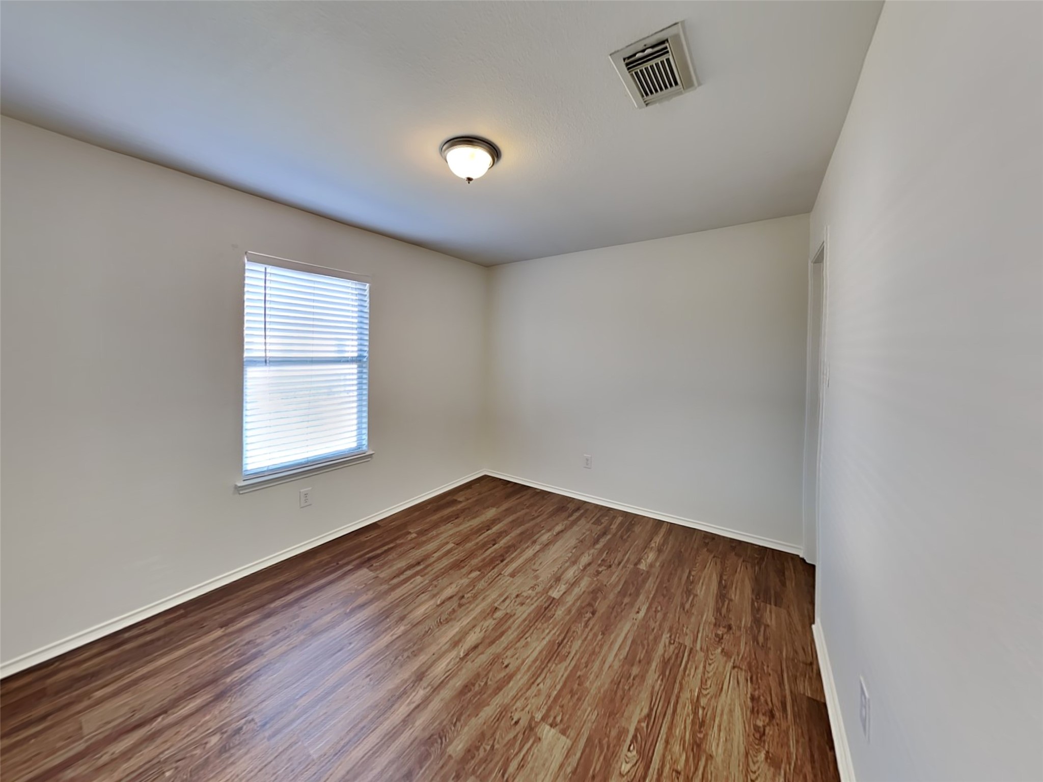 20930 Baronsledge Lane Katy, TX 77449 - Photo 14 of 21 an empty room with wooden floor and windows