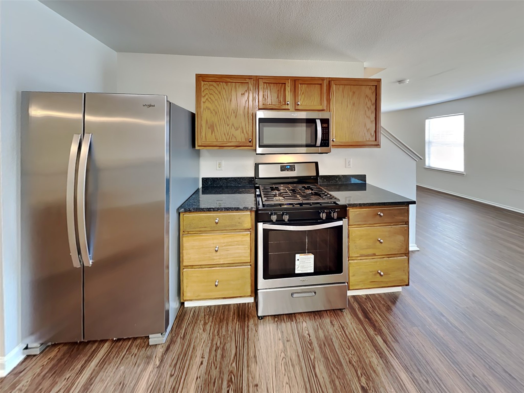 20930 Baronsledge Lane Katy, TX 77449 - Photo 4 of 21 a kitchen with stainless steel appliances a refrigerator stove and microwave