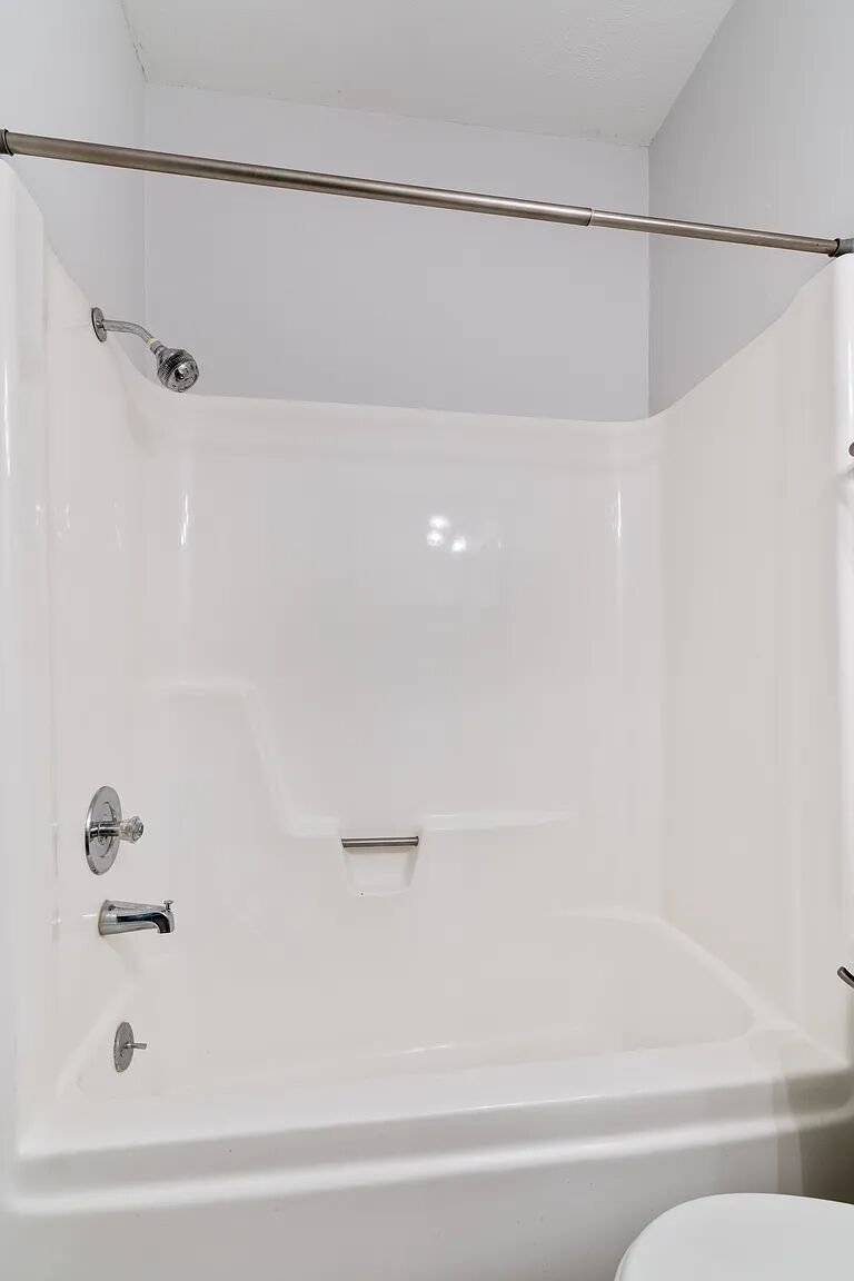 11970 Jollyville Road, Unit 202 Austin, TX 78759 - Photo 20 of 25 A well-maintained shower and tub combination provides practical utility in this bathroom.