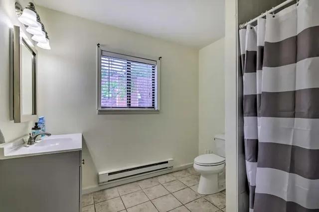 a bathroom with a sink a toilet a shower and a mirror