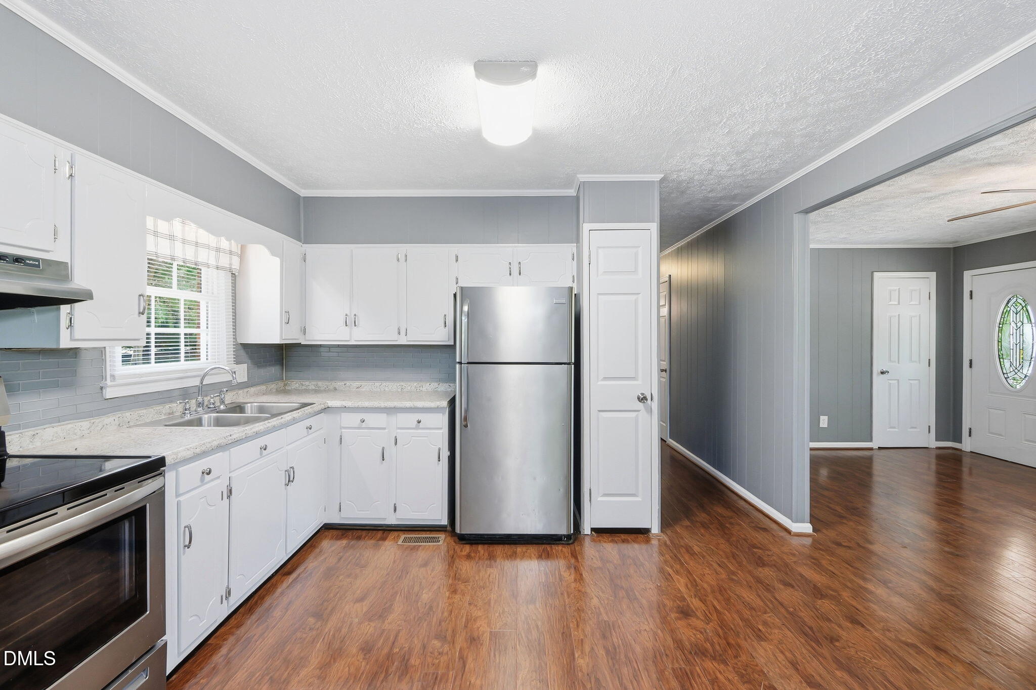 265 Shady Hill Circle Roxboro, NC 27573 - Photo 6 of 18 a kitchen with a sink a refrigerator and a stove
