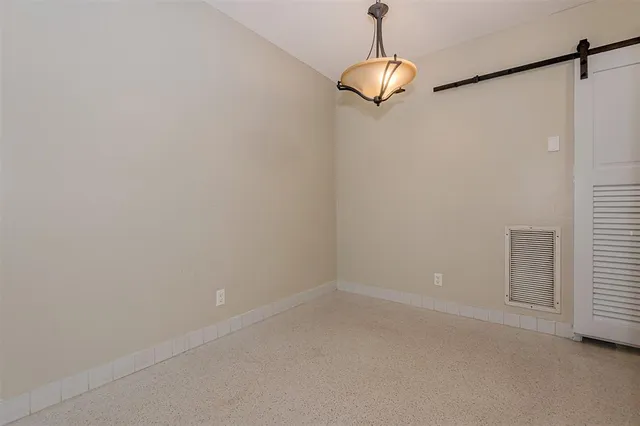 a room view with a chandelier fan