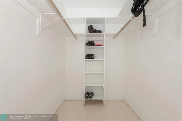a view of walk in closet with empty racks