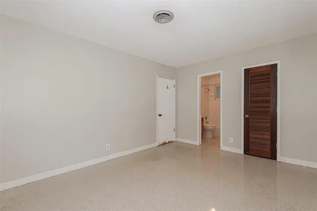 an empty room with closet area