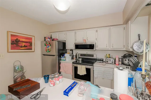 a kitchen with stainless steel appliances a stove a sink and a refrigerator