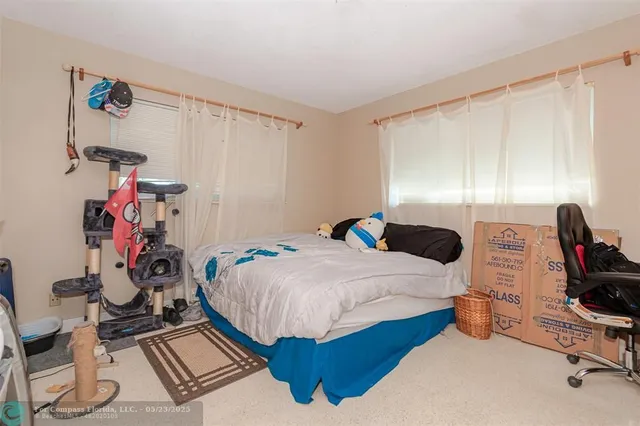 a bedroom with bed and a window