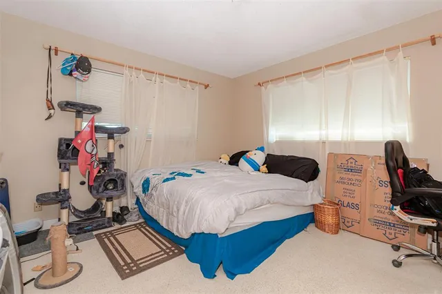 a bedroom with bed and a window