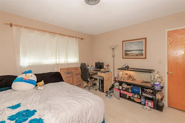 a bedroom with a bed a desk and chair