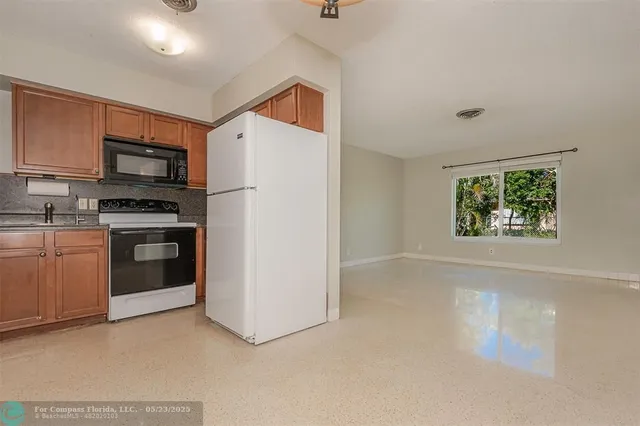 a kitchen with a stove a microwave and a refrigerator