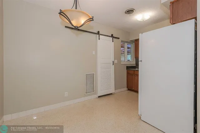 a view of a refrigerator in a kitchen