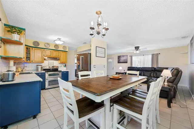a view of a dining room with furniture and a chandelier
