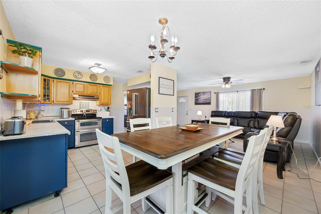 4124 Pine Dale Court Hernando Beach, FL 34607 - Photo 11 of 19 a view of a dining room with furniture and a chandelier