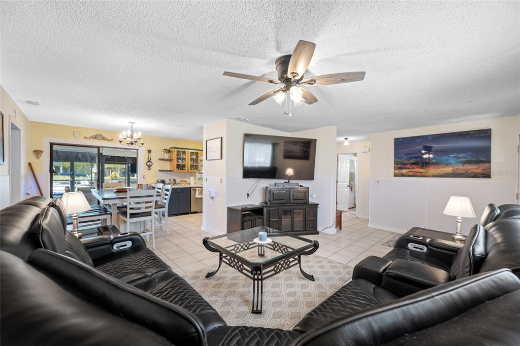 4124 Pine Dale Court Hernando Beach, FL 34607 - Photo 12 of 19 a living room with furniture and a fireplace