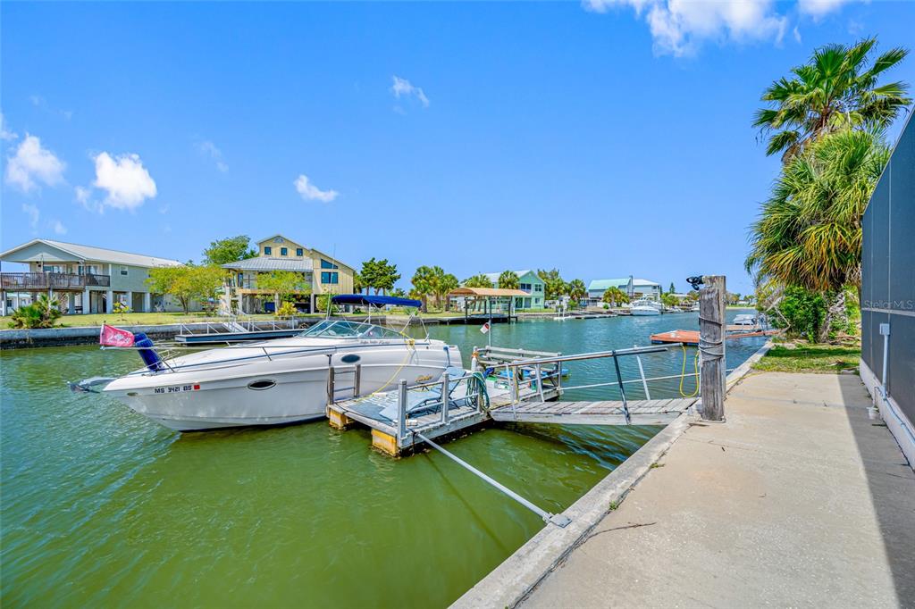 4124 Pine Dale Court Hernando Beach, FL 34607 - Photo 16 of 19 a view of a swimming pool with lounge chairs in patio