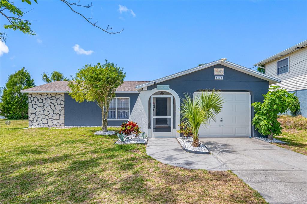 4124 Pine Dale Court Hernando Beach, FL 34607 - Photo 2 of 19 a front view of a house with garden