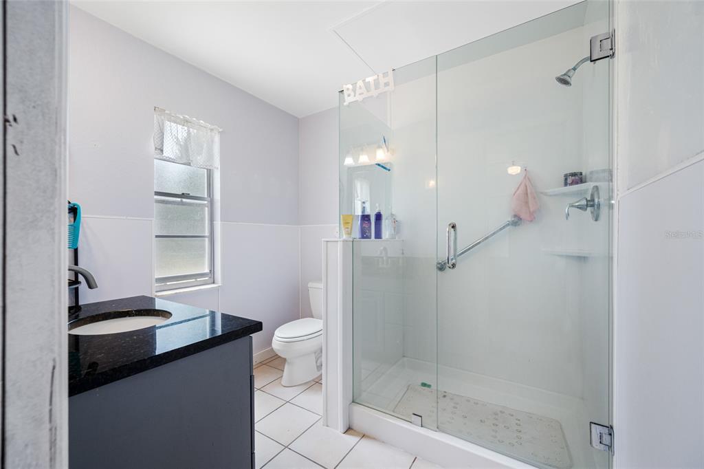 4124 Pine Dale Court Hernando Beach, FL 34607 - Photo 3 of 19 a bathroom with a sink a toilet a mirror and shower