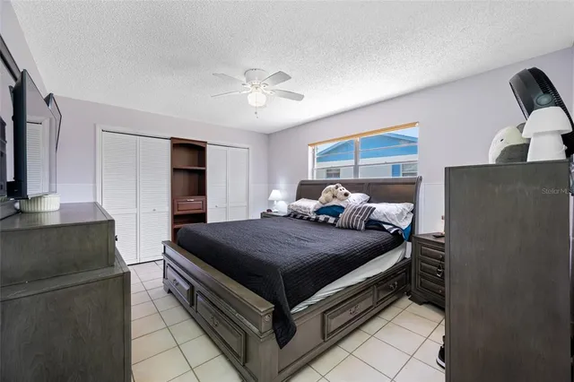 a bed room with bed and mirror