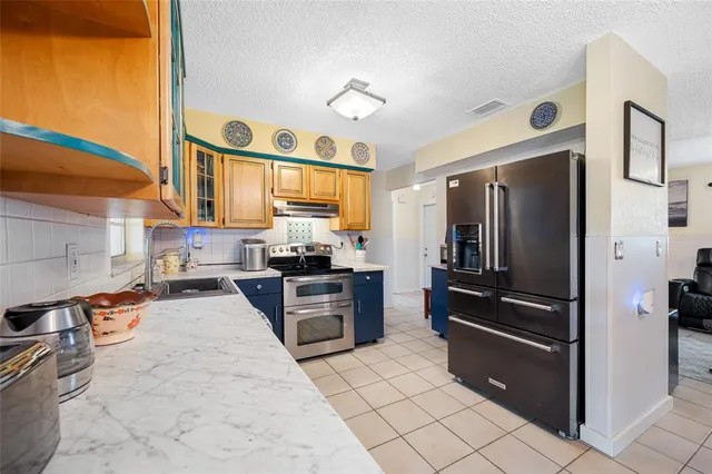 a kitchen with stainless steel appliances cabinets and a counter top space