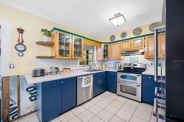 a kitchen with stainless steel appliances granite countertop a stove and a sink