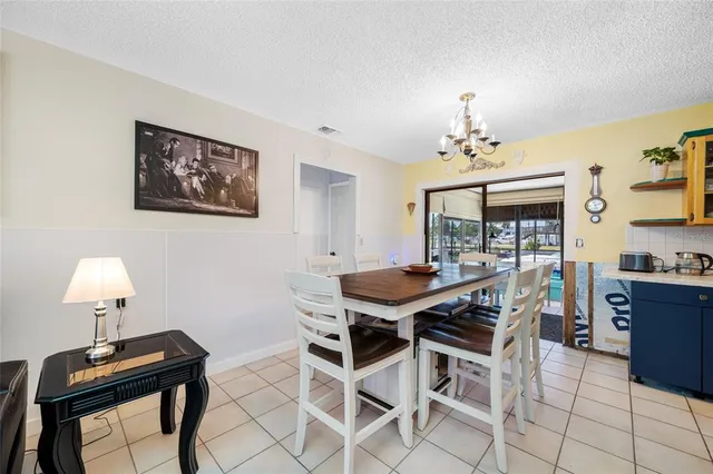 a view of a dining room with furniture and chandelier