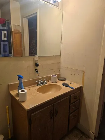 a bathroom with a sink and a mirror