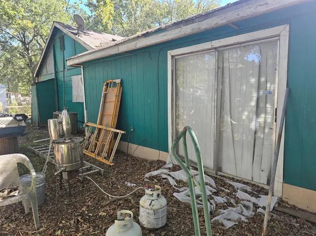 a view of a yard with wooden fence