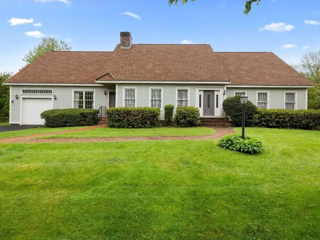 a view of a house with a yard and plants