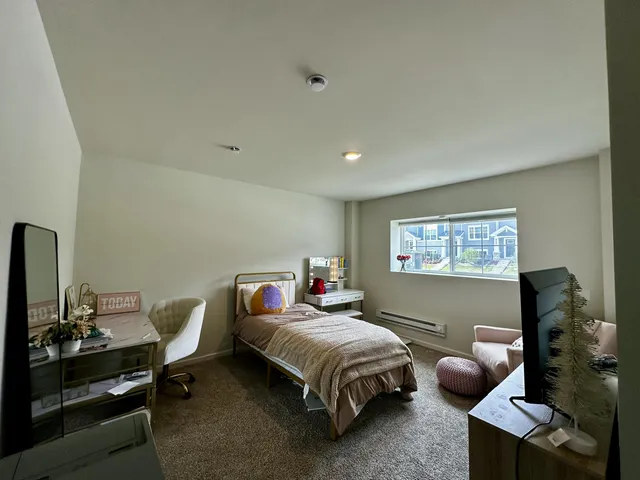 a bedroom with a bed and a couch