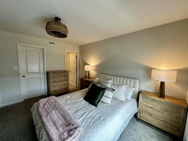 a bedroom with a bed and a lamp