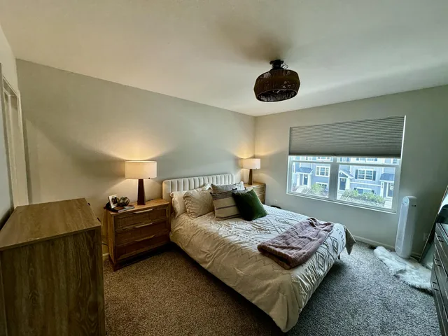 a bedroom with a bed and window