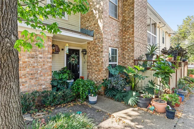 a view of a house with potted plants
