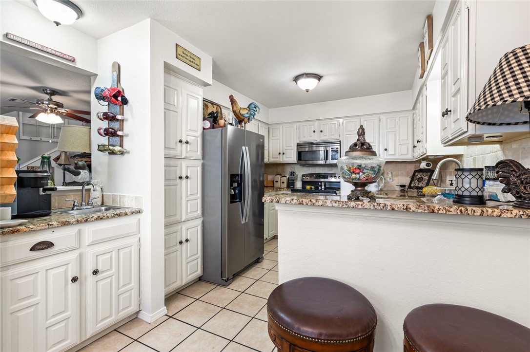 3813 Kimberly Drive, Unit B1 Waco, TX 76708 - Photo 14 of 30 a kitchen with stainless steel appliances a sink cabinets and wooden floor