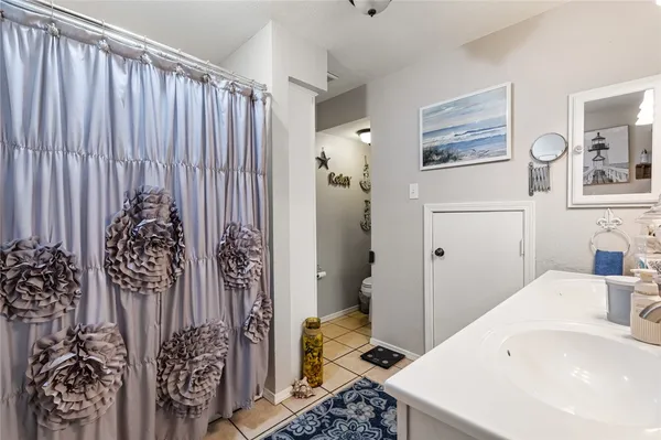 a bathroom with a sink and a shower curtain