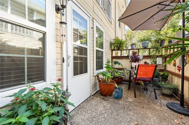 a view of a patio with table and chairs and potted plants